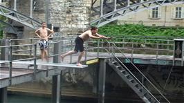 Lawrence does a good dive and front flip into the river